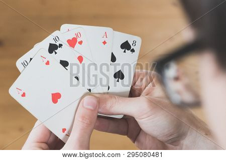 Playing Cards: Poker Cards In The Hand Of A Man