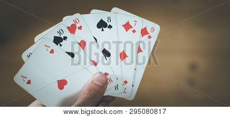 Playing Cards: Poker Cards In The Hand Of A Man