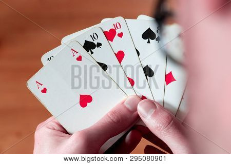Playing Cards: Poker Cards In The Hand Of A Man