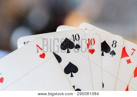 Playing Cards: Poker Cards In The Hand Of A Man