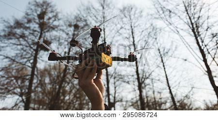 Pilot Racing Drone Holds In His Hand Fpv Copter Before Launching It. A Small High-speed Aircraft Wit