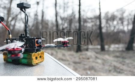 Fpv Drone Lies On The Table. The Pilot Sets Up His Racing Drone Before The Flight.