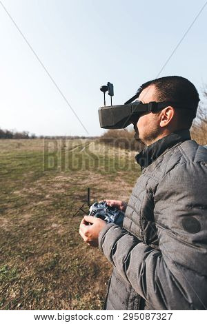 Fpv Drone Pilot In A Virtual Reality Helmet With A Remote Control From A Copter Flies In Aircraft Ou