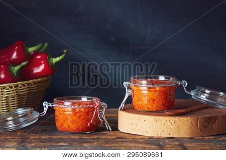 Roasted red pepper relish (Ajvar) in jars on table