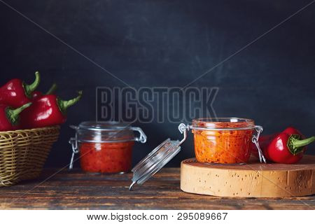 Roasted red pepper relish (Ajvar) in jars on table