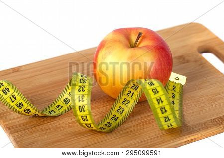 Apple, Orange, Kiwi With Measure Tape On White Background