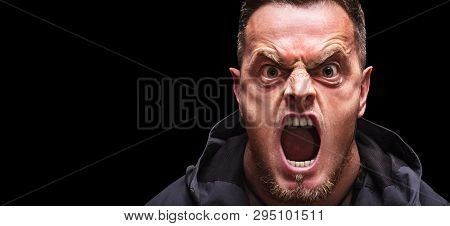 Angry Scarry Shouting Man On A Black Background.
