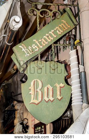 An Old Sign For A Restaurant And Bar