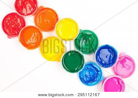Motley Paints On The White Background. Paints Arranged As Rainbow. Studio Shot
