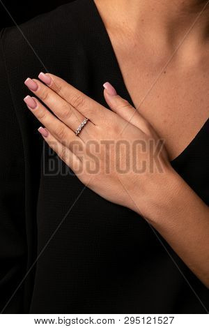 Womens Silver Diamonds Ring With A Fringe On Finger, On A Black Background.
