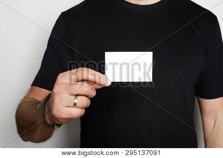 Male Model Poses In Casual Blank Black T-shirt Premium Summer Cotton And Holding Hand Empty White Bu