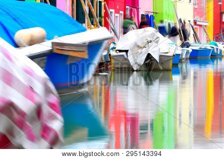 Coloured Houses Reflecting In Water At Burano, In Venice Laguna, Italy