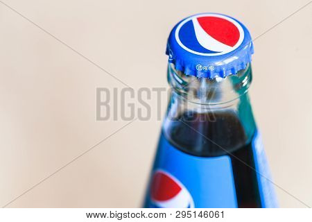 Moscow, Russia - April 4, 2019: Top Of Closed Pepsi Glass Bottle Close Up. Pepsi Is Carbonated Soft 
