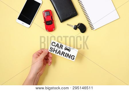 Car Sharing Concept. Human Hand Holding Text Sign 