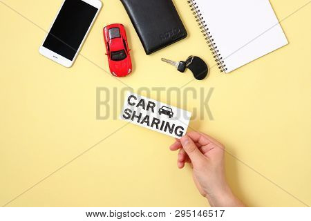 Car Sharing Concept. Human Hand Holding Text Sign 