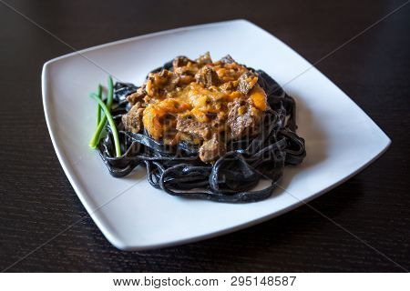 Black Pasta With Cuttlefish Ink. Pasta Of Durum Wheat Semolina With Squid Ink With Beef And Sweet Pe