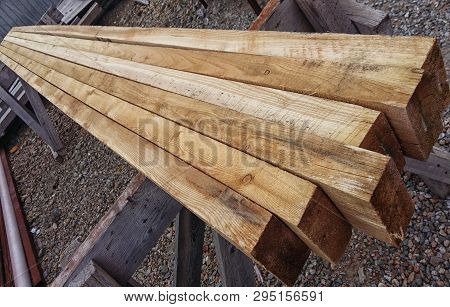 Edged Boards Of Natural Wood Lie In A Row Unpolished With Burrs