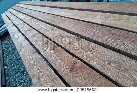 Edged Boards Of Natural Wood Lie In A Row Unpolished With Burrs