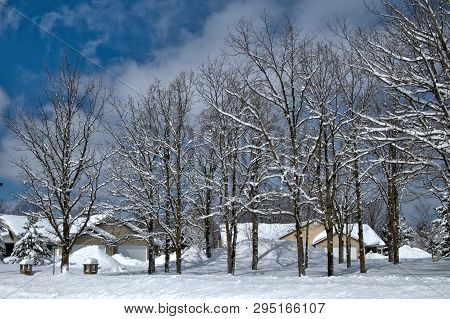 Snow Piles In Front Of Houses In Minnesota Residential Community After Winter Storms With Snow Cover