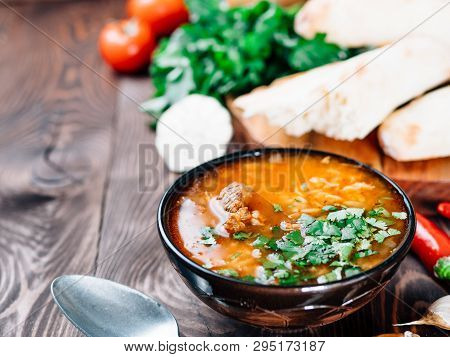 Traditional Georgian Kitchen-soup Kharcho With Meat, Rice And Fresh Cilantro. Spicy Soup Kharcho On 