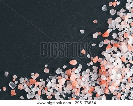 Himalayan Pink Salt In Crystals On Black Stone Background. Copy Space