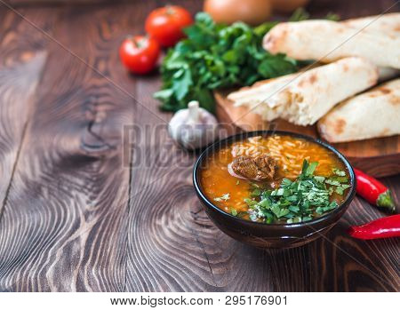 Traditional Georgian Kitchen-soup Kharcho With Meat, Rice And Fresh Cilantro. Spicy Soup Kharcho On 