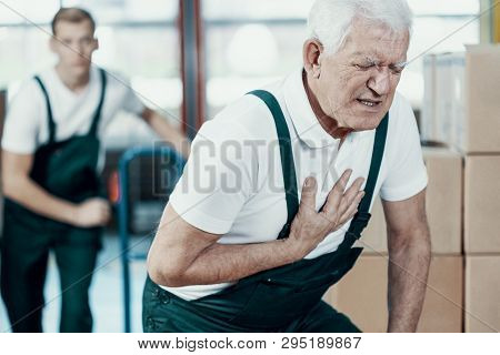 Senior Warehouseman Having A Heart Attack At Work