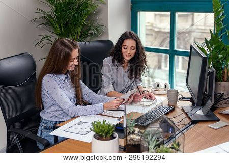 Smiling Female Architect Choosing Some Color From Colors Palatte On The Modern Office Background.