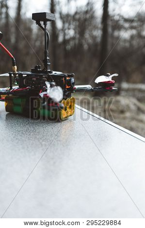 Fpv Drone Lies On The Table. The Pilot Sets Up His Racing Drone Before The Flight.