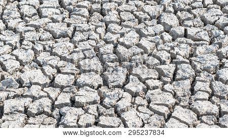 Drought And Desertification Of Dry Waterless Land, Cracked Mud, Arid Ground Soil For Environmental C