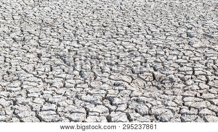 Drought And Desertification Of Dry Waterless Land, Cracked Mud, Arid Ground Soil For Environmental C