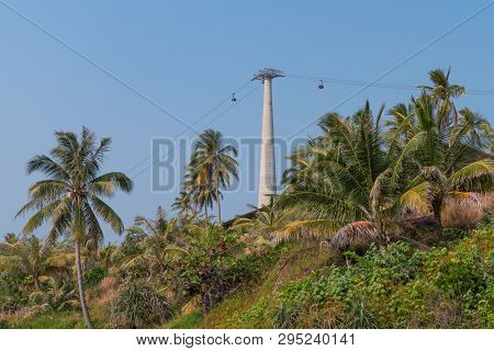 View Of The Shore Of A Tropical Island With Palm Trees And Cable Car