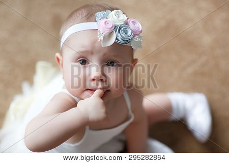 A Small Child Of 5 Months Is Having Fun Alone, Crawling On The Bed.baby Girl Crawling On Bed And Lau