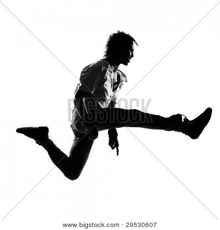 full length silhouet van een jonge man danser dansen funky hip hop r&b op geïsoleerde studio witte ba