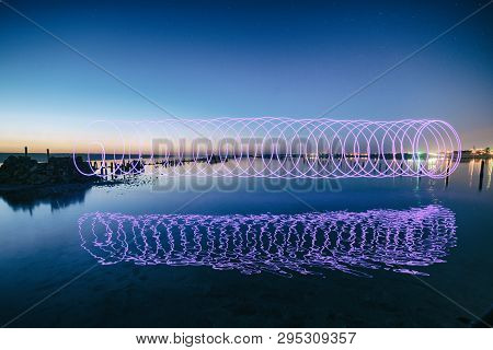 Amazing Laser Fireshow Performance In The Night Blue Sky With Reflections In The Sea Water