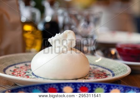 Closeup Fresh Local Italian Soft Round Buratta On Round Color Beautiful Plate With A Pattern Served