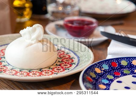 Closeup Fresh Local Italian Soft Round Buratta On Round Color Beautiful Plate With A Pattern Served