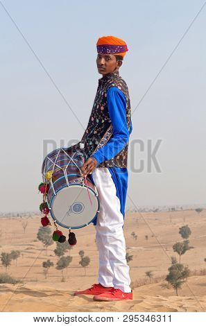 Bikaner, India - January 12, 2019: Indian Drummer In Traditional Clothes Performing During Camel Fes