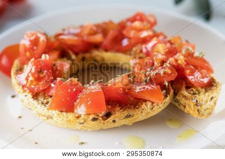 Tipical Summer Dish Of Puglia - Friselle. Classical Frisella With Tomato, Oregano And Olive Oil. Dri