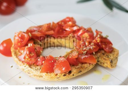 Tipical Summer Dish Of Puglia - Friselle. Classical Frisella With Tomato, Oregano And Olive Oil. Dri