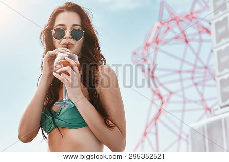 The Summer Cooldown. Portrait Of Slim Fashion Model In Green Swimsuit Posing Near The Pool. Horizont