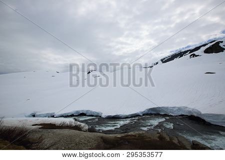 Spring Glacial River Of Melting Snow In Mountains Of Norway