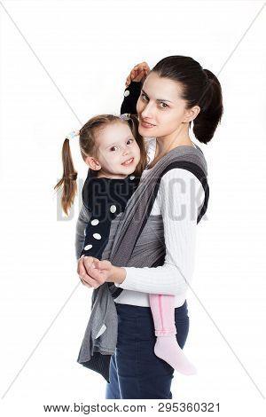 A Toddler Girl In Front Vertical Position In Baby Carrier