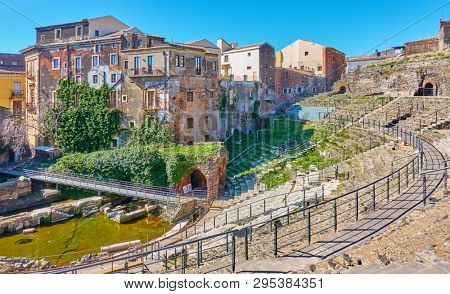 Old buildings on ancient ruins of roman theater in Catania, Sicily, Italy