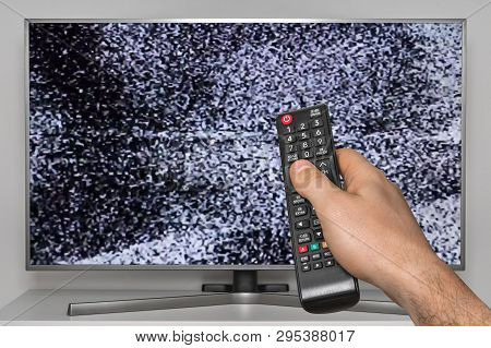 Analog Noise On Tv And Human Hand With Tv Remote Controller