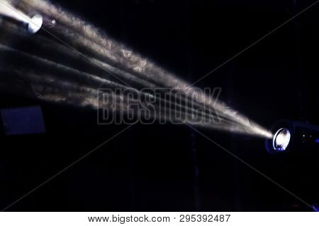 Stage Lights. Several Projectors In The Dark. Multi-colored Light Beams From The Stage Spotlights On