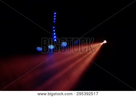 Stage Lights. Several Projectors In The Dark. Multi-colored Light Beams From The Stage Spotlights On