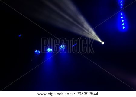 Stage Lights. Several Projectors In The Dark. Multi-colored Light Beams From The Stage Spotlights On