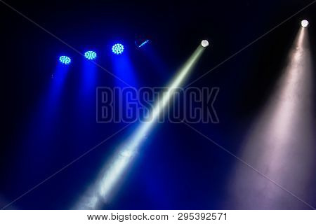 Stage Lights. Several Projectors In The Dark. Multi-colored Light Beams From The Stage Spotlights On