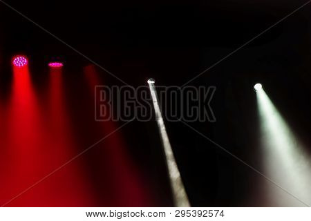 Stage Lights. Several Projectors In The Dark. Multi-colored Light Beams From The Stage Spotlights On